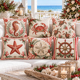 Six coastal Christmas cushion covers with seahorse, crab, sea turtle, starfish, sand dollar and ship’s helm designs on a beach-house sofa