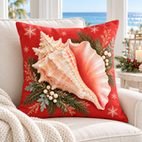 Coral-red Christmas conch shell cushion cover with evergreen and snowflakes styled in a coastal Christmas room
